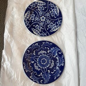 Set of blue & white floral painted ceramic plates, about 7.5 in diameter.